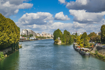 Seine river in Paris with tourist boat on it on beautiful sunny day.