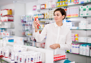 Cheerful female customer looking for products
