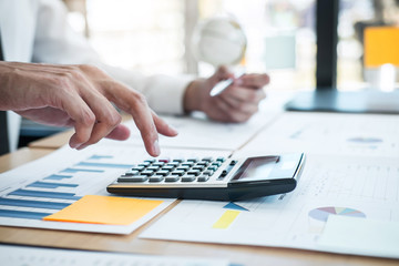 Obraz na płótnie Canvas Businessman working analyzing and calculate expense financial annual report