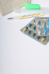 Cold treatment. Tablets For lowering the temperature during the flu. The recipe form is visible. Lie next to the thermometer to measure body temperature.