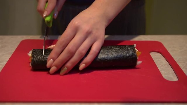 Close up of a woman preparing homemade sushi