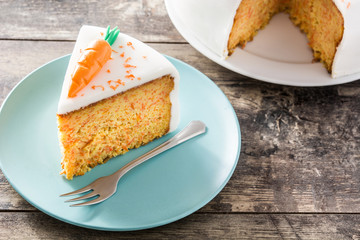 Sweet carrot cake slice on wooden table