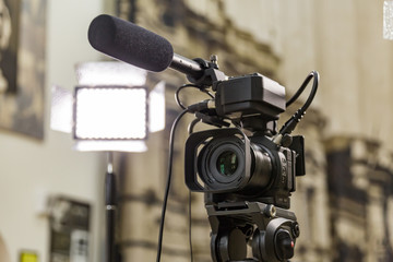Shooting a report in the interior. Video equipment: camera, on-camera microphone gun, led lighting...