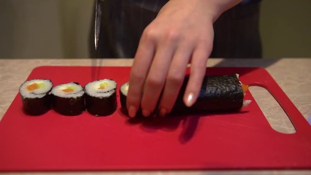 Close up of a woman preparing homemade sushi