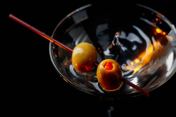 Martini cocktail with green olives.