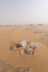 A sandstorm giving a mysterious atmosphere to the already bizarre landscapes of the White Desert National Park in Egypt