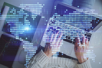 Double exposure of World map polygonal with person typing on laptop. Globalization concept.