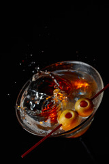 Martini cocktail with green olives.