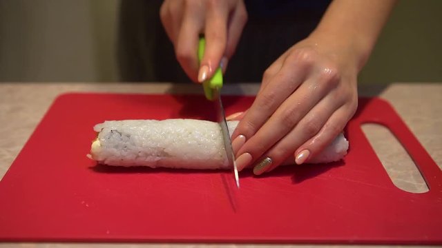 Close up of a woman preparing homemade sushi