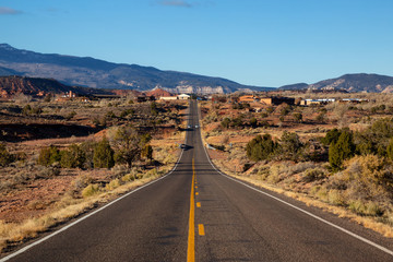 Scenic road in the desert during a vibrant sunny sunrise. Taken on Route 24 near Torrey, Utah, United States of America. - obrazy, fototapety, plakaty
