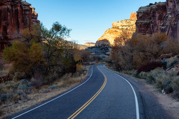 Scenic road in the desert during a vibrant sunny sunrise. Taken on Route 24, Utah, United States of America.