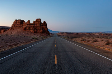 Scenic road in the desert during a vibrant sunny sunrise. Taken on Route 24, Utah, United States of America.