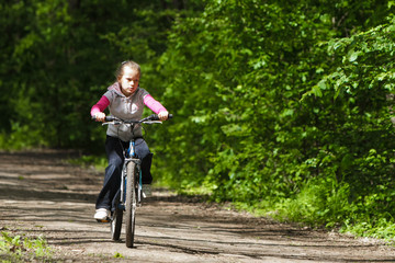 Girl on a bike in the forest