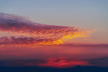 Sunny shine on clouds. Wonderful vivid dawn. Beautiful calm magenta sunset. Scenic surreal sunrise. Amazing pink cloudy sky. Sun above horizon. Picturesque sundown. Atmospheric cloudscape. Background.