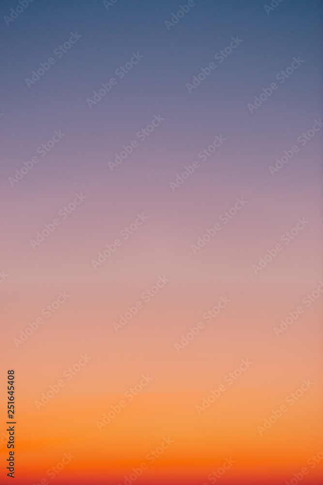 Wall mural predawn clear sky with orange horizon and violet atmosphere. smooth orange violet gradient of dawn s