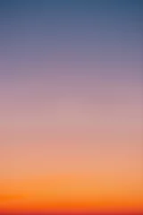 Foto auf Acrylglas Predawn clear sky with orange horizon and violet atmosphere. Smooth orange violet gradient of dawn sky. Background of day beginning. Heaven at early morning with copy space. Sunset, sunrise backdrop © Daniil
