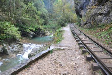 Narrow-gauge railway goes along the river Kurdzhips. Guam Gorge. Krasnodar region, Russia