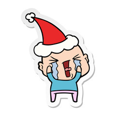 sticker cartoon of a crying bald man wearing santa hat