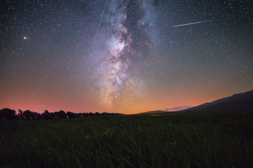 Beautiful night landscape, Green field and milky way galaxy. 