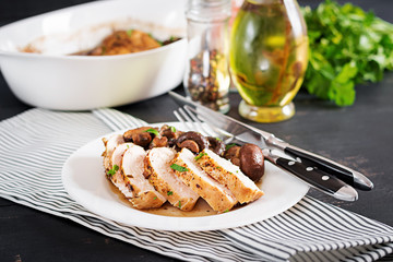 Baked chicken breast with mushrooms in balsamic  sauce  on the table.
