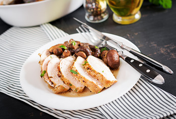 Baked chicken breast with mushrooms in balsamic  sauce  on the table.