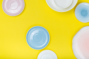 Clean  porcelain dishes on yellow  background