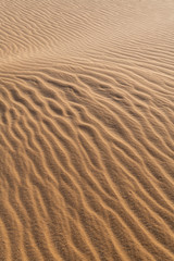 Fototapeta na wymiar Amazing abstract background image of ripples and waves in the sand at sunrise