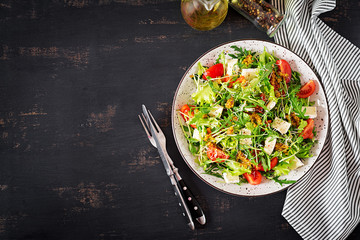 Tomato salad with mix micro greens and  camembert cheese. Top view