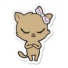 Obraz na płótnie Canvas sticker of a cute cartoon cat with bow