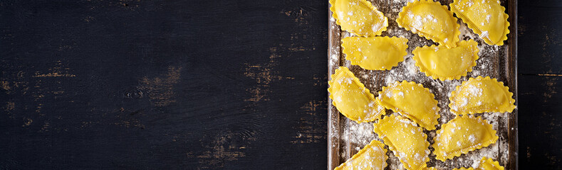 Uncooked ravioli on table. Italian cuisine. Banner. Top view