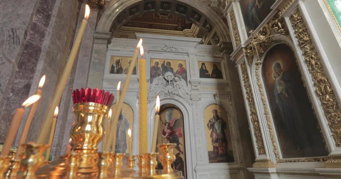 Interiors of Isaac cathedral, nobody, gold is everywhere, candles, icons, sun, big window, museum, 4k video, stucco molding, heritage