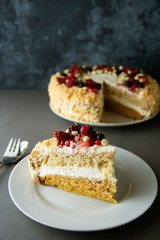 Vegan delicious carrot and orange cake decorated with berries. Healthy dessert. Grey background. Piece of cake.