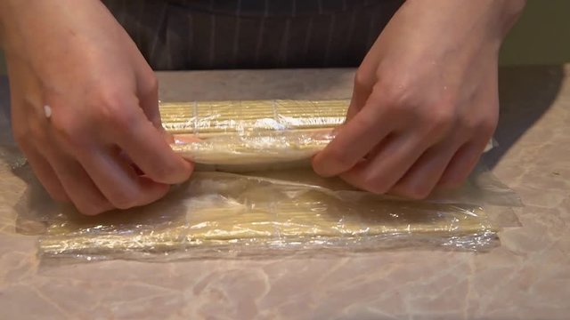 Close up of a woman preparing homemade sushi