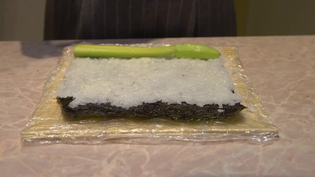 Close up of a woman preparing homemade sushi