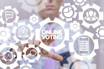 Man uses on a virtual gears screen of the future and touches the inscription: online voting....