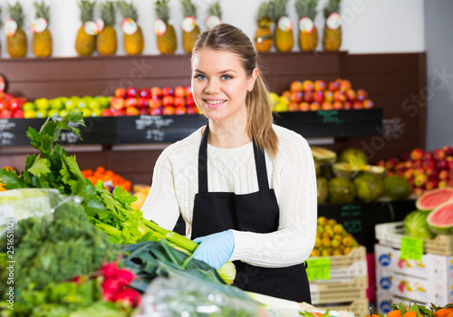Salesgirl arranging greens