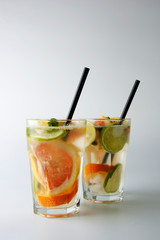 Traditional summer drink lemonade. With strawberries, oranges, lemon, lime, and grapefruit. Vertical iamge, toned.