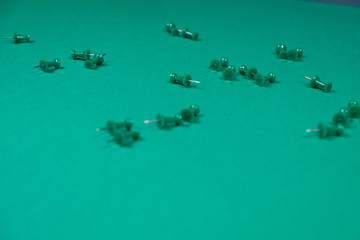 Green pins needles on a green background!