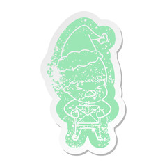 cartoon distressed sticker of a stressed man wearing santa hat
