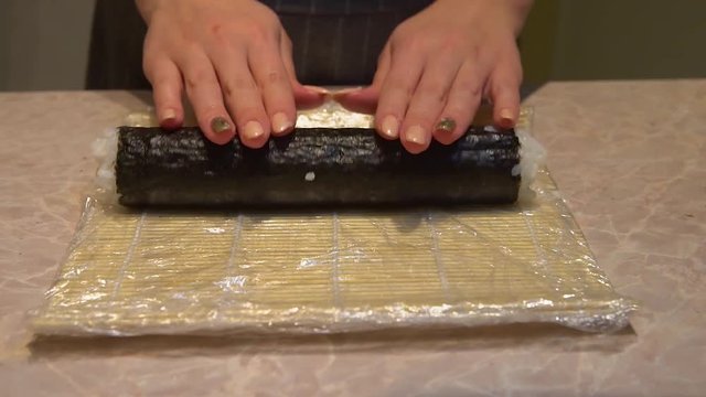 Close up of a woman preparing homemade sushi