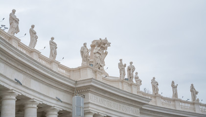 Fototapeta na wymiar Vatican City, Rome, Italy - February 23, 2019: Part of the architectural structure on the square of the Vatican, Rome. Angels on the roof.