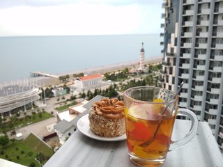 a glass of tea and cake on the balcony, sea view