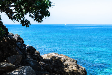 Coastline cliffside view of the ocean. Caribbean tropical island landscape/seascape scenery.