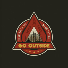 Hand drawn adventure logo with camp tent, mountains, pine trees forest and quote - Go outside, wild and free, five billion star hotel. Old style outdoors adventure emblem in retro style. Stock vector