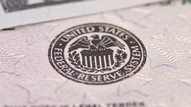 Federal Reserve System icon on United States dollar bill.