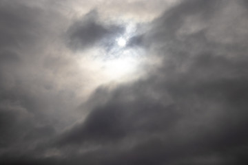 dark clouds in the sky and rays of light pierce through them