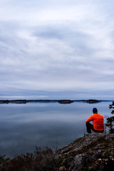 Man sitting by sea