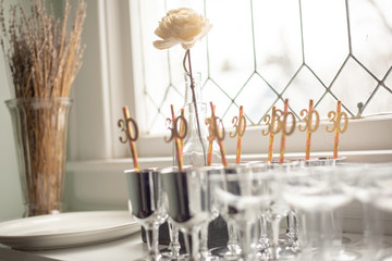 Fototapeta na wymiar 30th celebration straws in party glasses