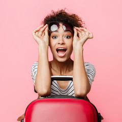 Surprised girl in sunglasses looking at camera