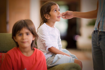 View of two small children sitting indoors.